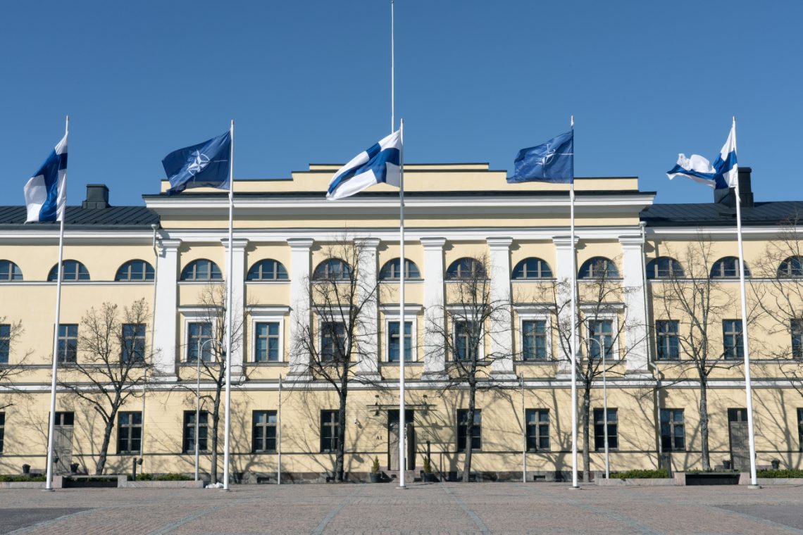 Finnish and NATO flags waving at the Finnish foreign ministry building.