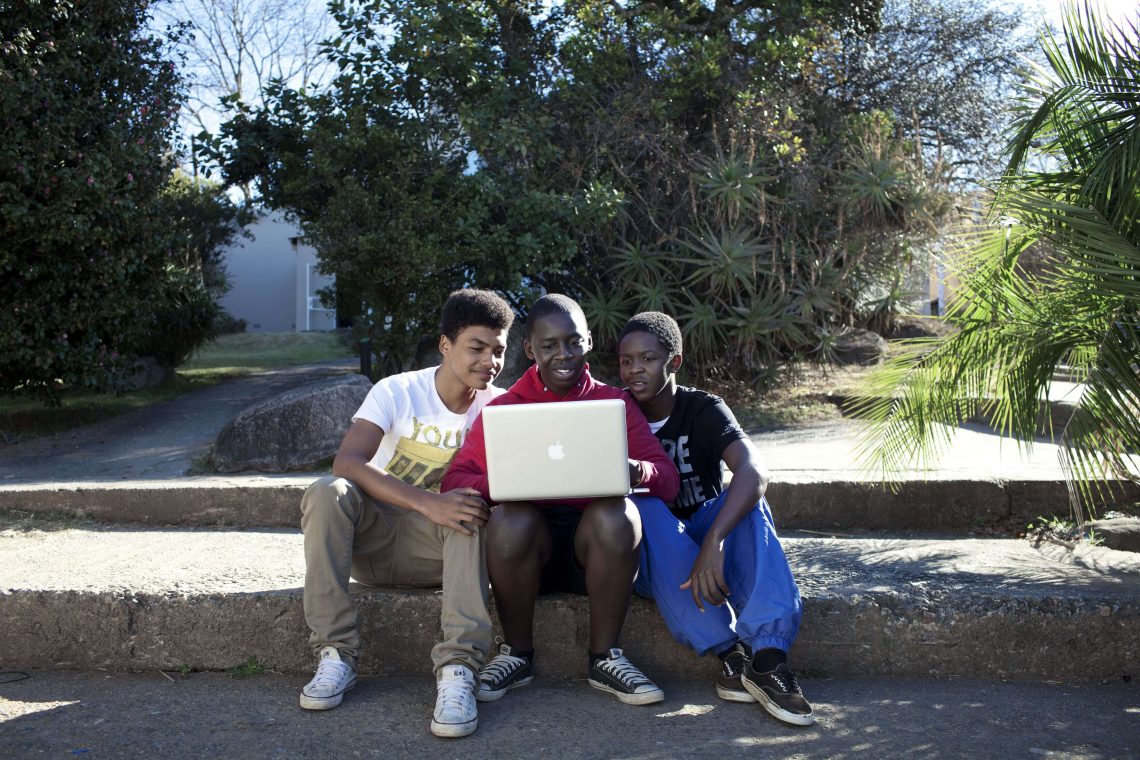 Students read on a laptop at a secondary school in Mbabane, Swaziland.
