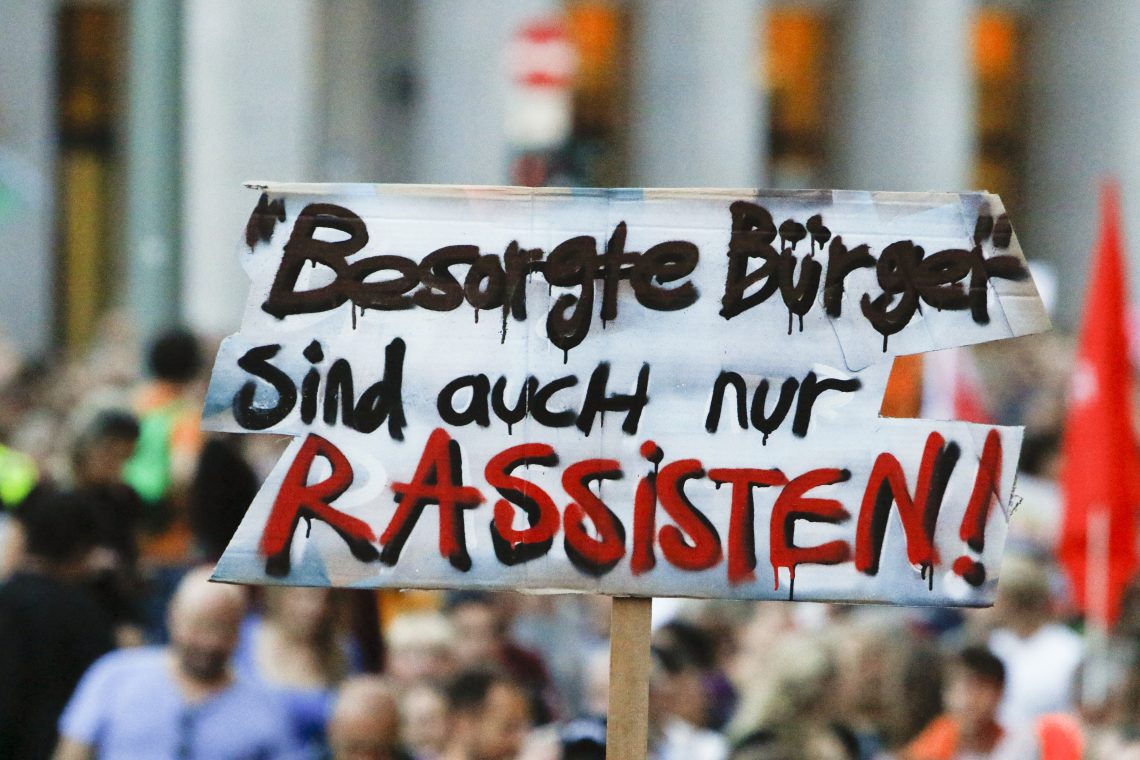 A protester in Frankfurt, Germany, in 2017 held up a sign reading “Concerned citizens are only racists.”