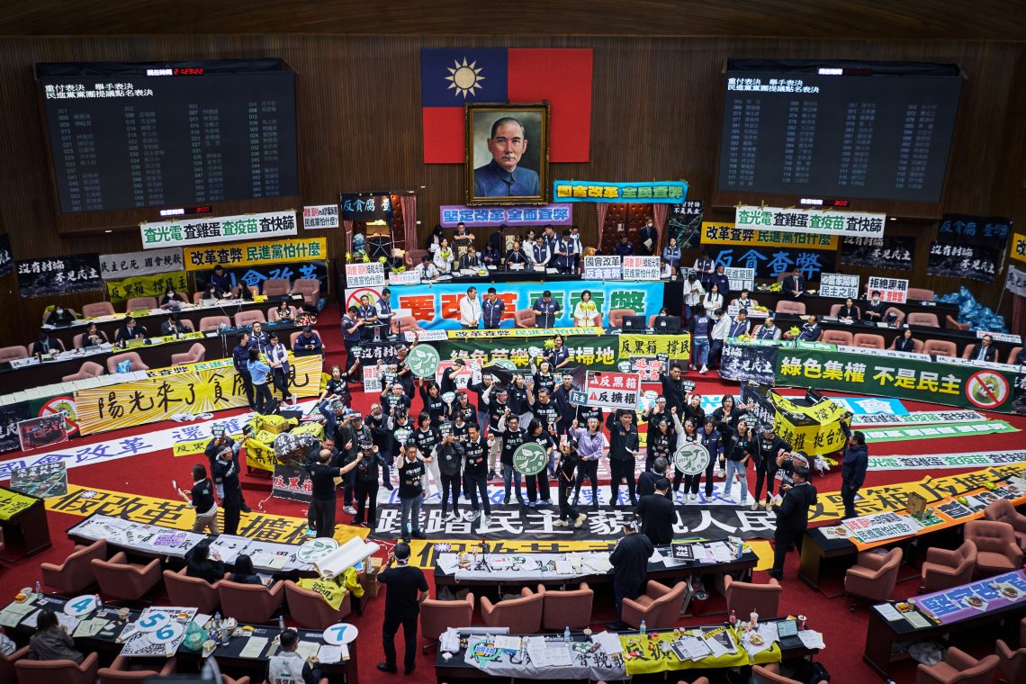 Members of the ruling Democratic Progressive Party (DPP) protest inside the Legislative Yuan, or parliament, in Taipei, Taiwan.