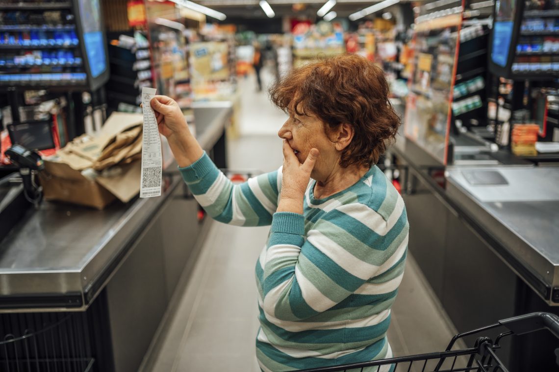 Woman looking at a grocery bill